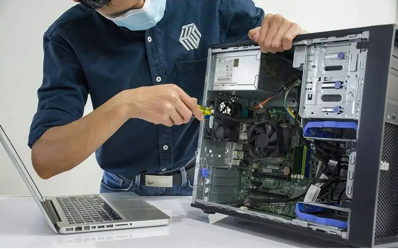 Precise pc repair technician performing PC performance upgradses